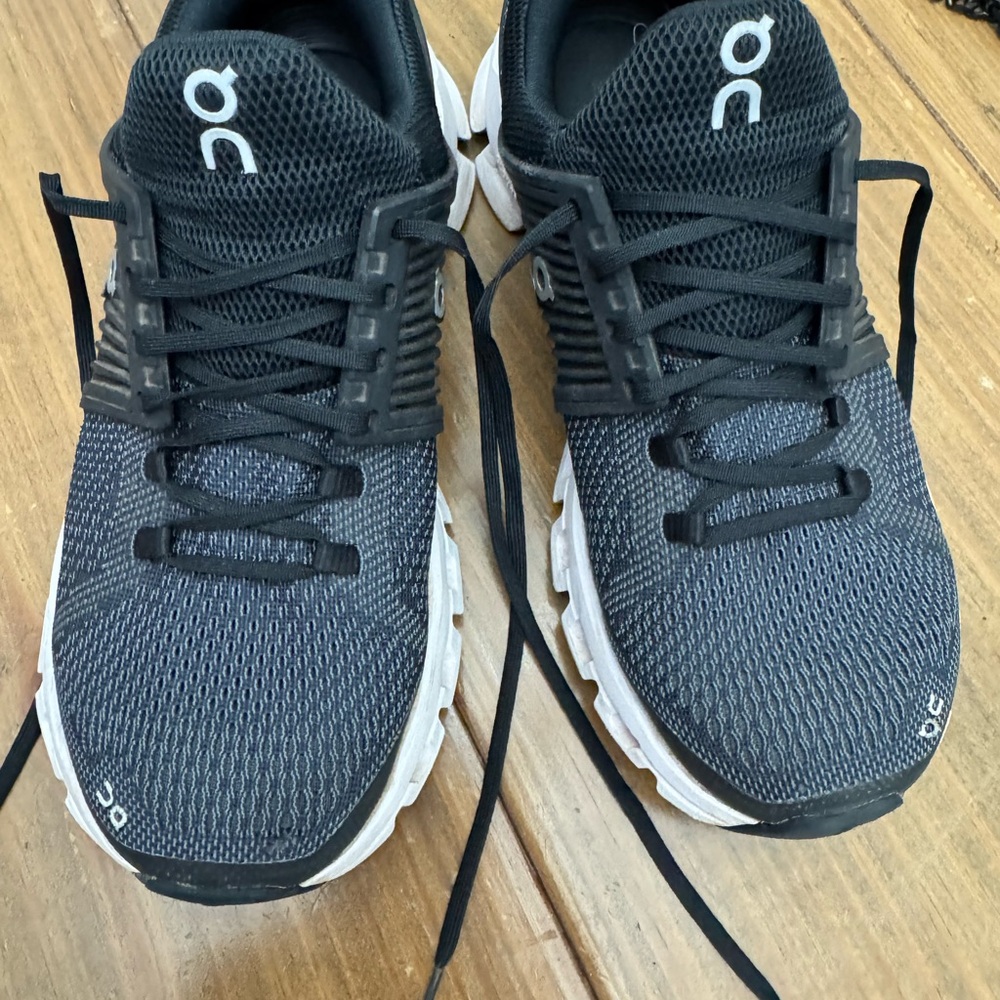 On Running Black and White Athletic Shoes with Cloud Cushioning